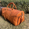 Genuine leather travel duffle bag with spacious main compartment, laptop pocket, shoe storage and reinforced leather carry handles.