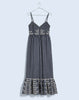  Gingham maxi dress with side pockets, a floral motif waist band, and a contrasting patterned ruffle hem.