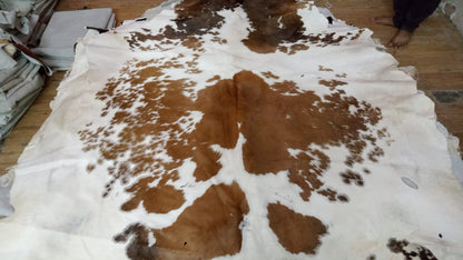 Experience the ultimate comfort underfoot with our plush yet durable brown and white cowhide rugs, designed to withstand the test of time.