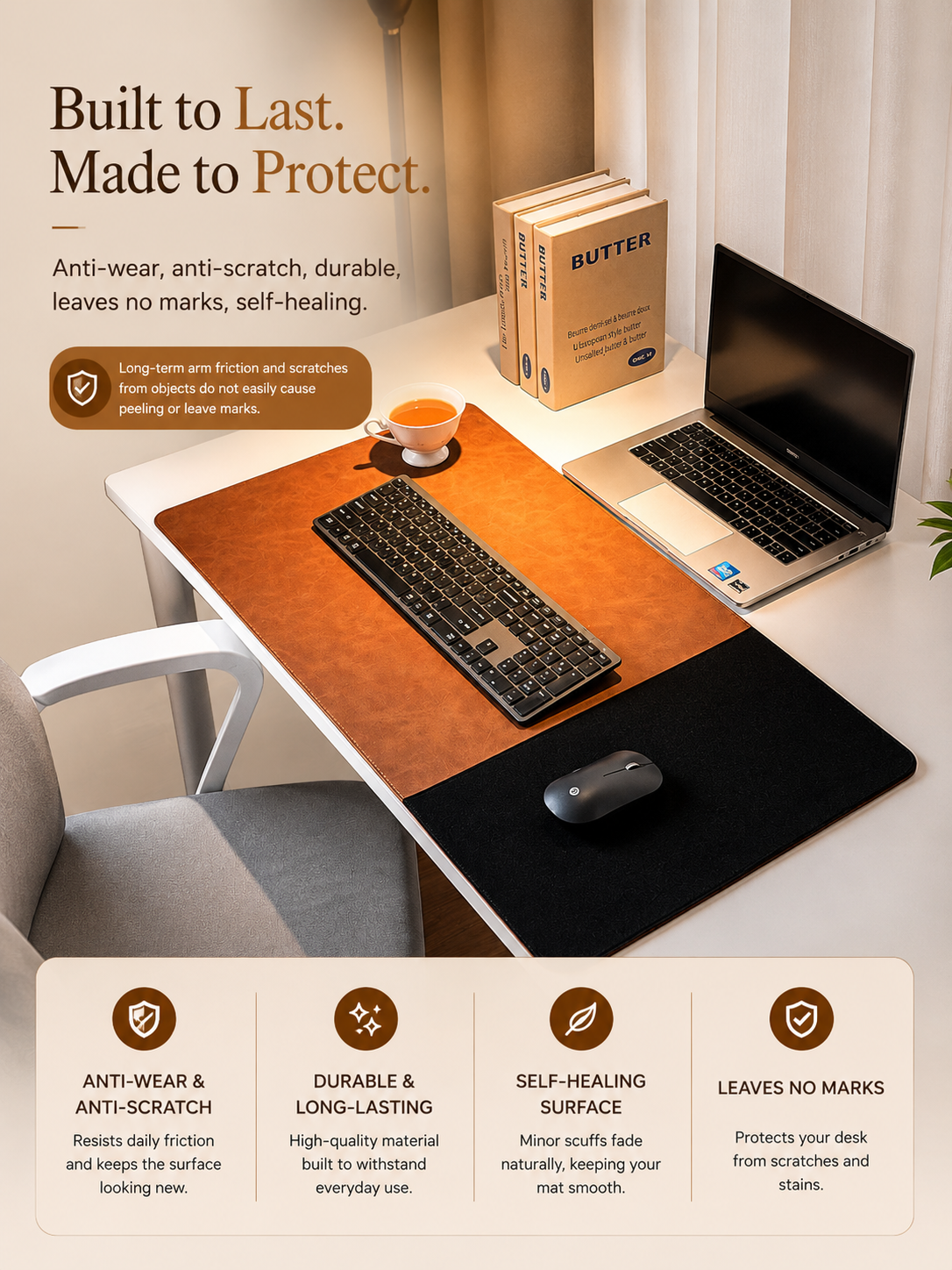 A desk mat with a wood-grain top and black underside shown on a white desk, with a keyboard, mouse, laptop, chair, and books around it. 