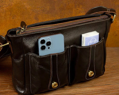 Leather satchel bag for men with open top showing organized interior space for tablet, notebook and accessories.