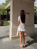 Cream knit mini dress with keyhole neck and ruffle hem