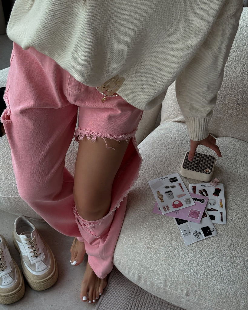 Pink distressed jeans with high waist and wide leg fit