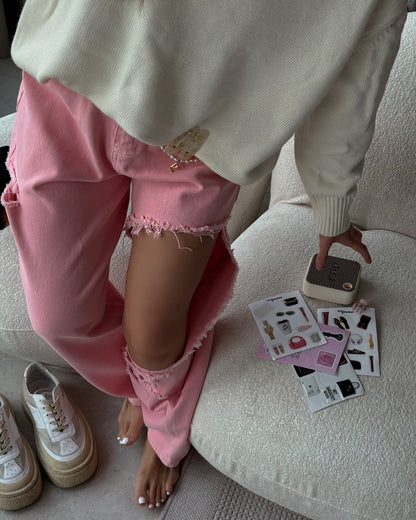 Pink distressed jeans with high waist and wide leg fit