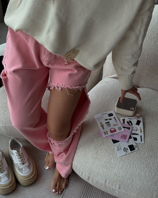 Pink distressed jeans with high waist and wide leg fit