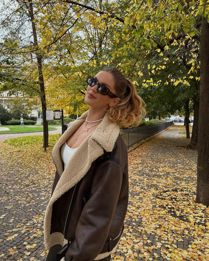 Brown shearling jacket with faux leather zip details
