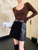 Women’s black leather mini skirt with suede contrast panels. High waisted, A-line, short skirt ideal for boots, tights, or evening looks.
