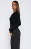 black fitted button-up top with a v-neckline