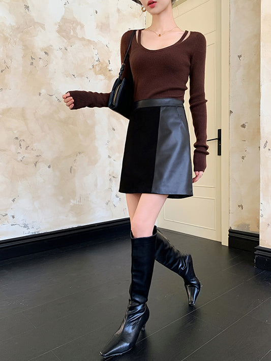 Black leather suede mini skirt for women with high waist A-line fit. Above knee design styled for day to night outfits and modern layering.