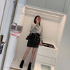 Black leather mini skirt for women with sleek zipper detailing and premium lambskin finish. A fitted silhouette perfect for autumn fashion and night styling.