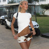 Hip-hugging cow print mini skirt