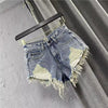 Women ripped denim shorts with fringe