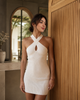 Cream crisscross halter dress with open back and keyhole
