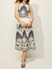 Ring-waist botanical midi dress with palm trees, leafy branches and small bird motifs.