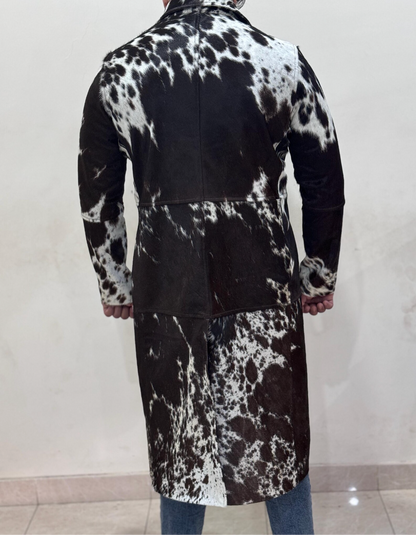 This long cowhide jacket showcases authentic black and white cowhide with a tailored fit. A bold cow fur trench coat ideal for rodeo life, ranch events, and cowgirl styling.

