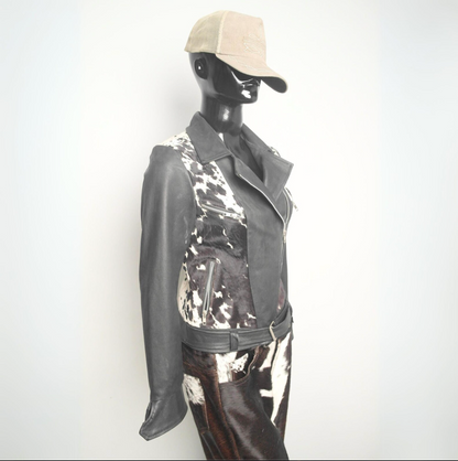 Black and white cowhide leather jacket for women with a belted waist, unique cow print, and bold western influence.


