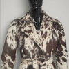 Women's cowhide jacket in a trench style, featuring real hair-on-hide, belted waist, and unique natural color variations.

