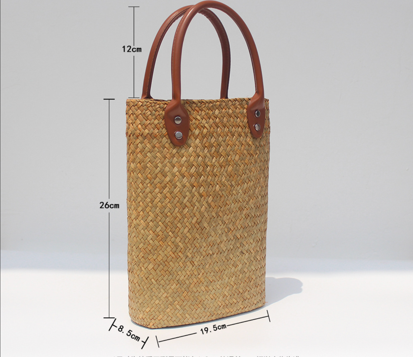 Natural straw beach tote with brown leather handles