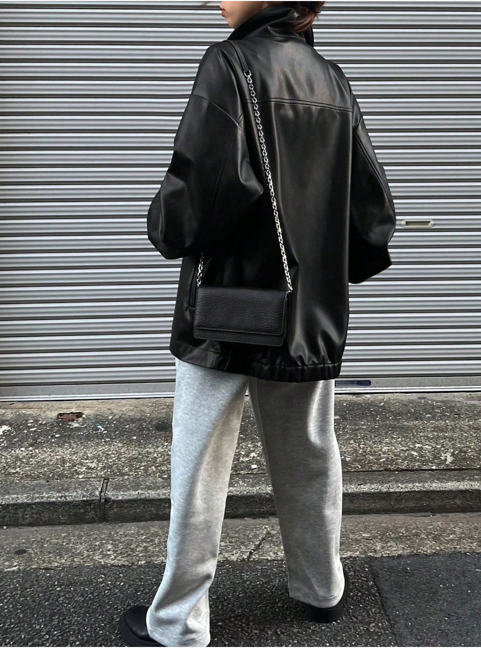 Oversized black leather jacket with drop shoulder