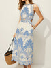Sleeveless tropical beach dress with a high neckline and softly gathered midi skirt.