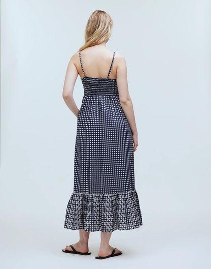 Dark grey long dress with a smocked back, narrow shoulder straps, and a softly gathered full-length skirt.