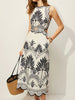 Tropical palm print midi dress with a sleeveless high neck, cutout waist and scalloped hem.
