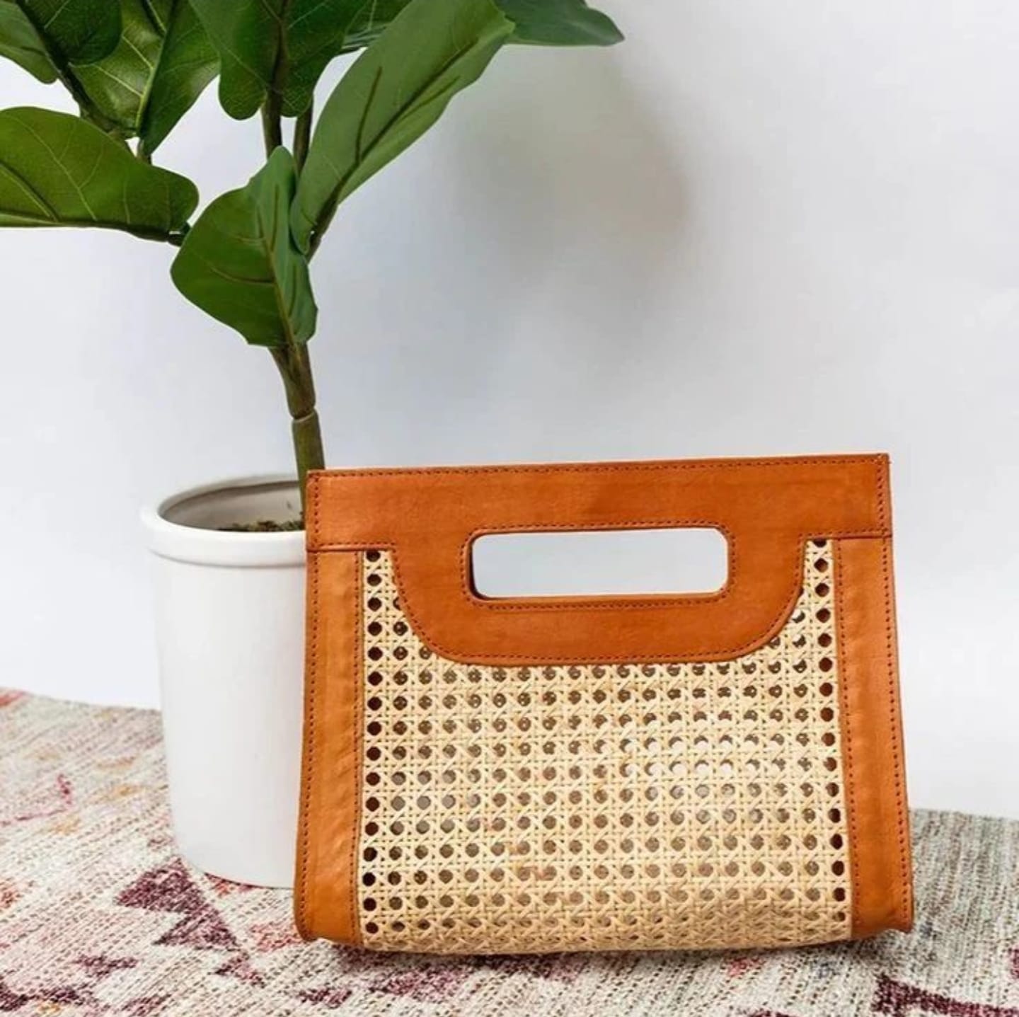 Indulge in luxury and sophistication with our V Style Leather Rattan Handbag. A perfect combination of functionality and style to complete your ensemble.