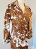 Genuine cowhide fur trench coat for women with ranch-inspired styling. Distinct natural hide patterns make each coat one of a kind.