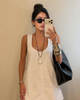 White scoop neck mini dress with wide straps and A-line shape