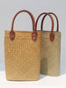 Natural straw beach tote with brown leather handles