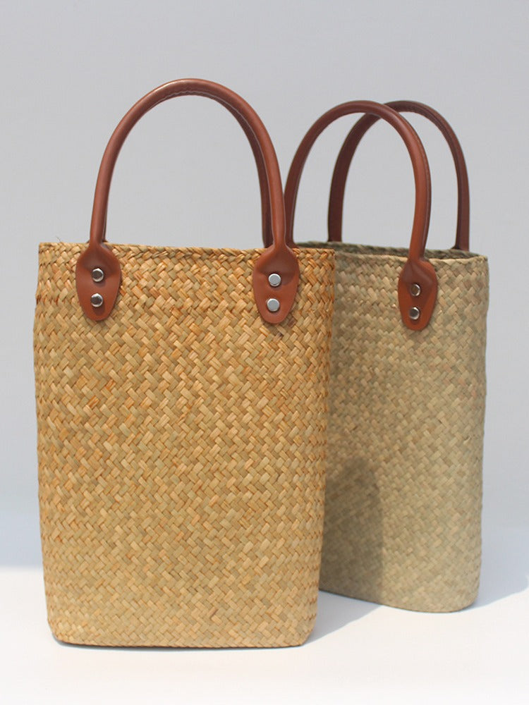 Natural straw beach tote with brown leather handles