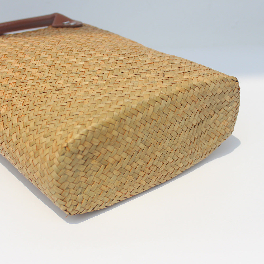 Natural straw beach tote with brown leather handles