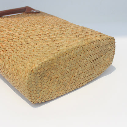 Natural straw beach tote with brown leather handles