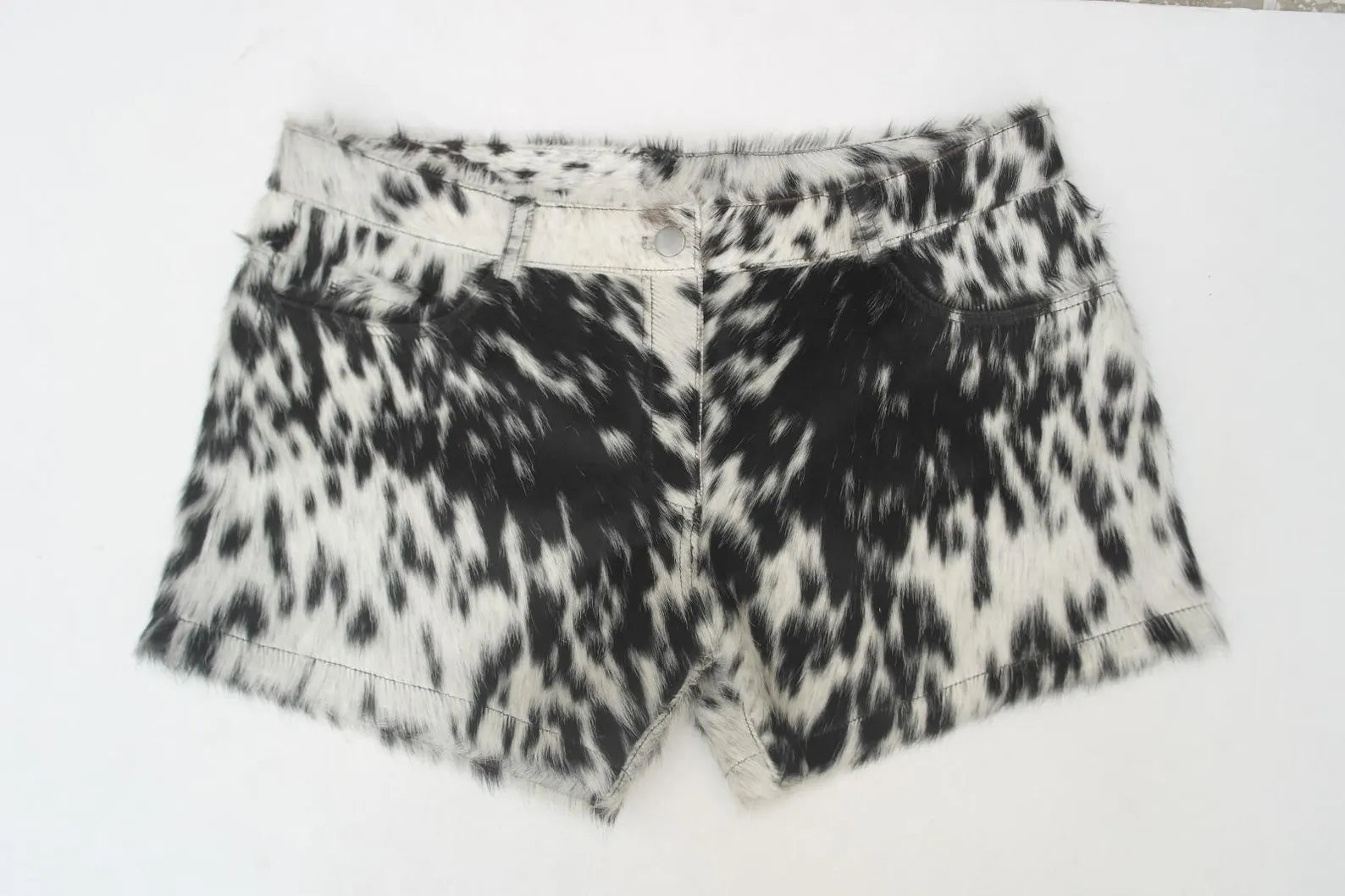 Stand out in real cowhide mini shorts for women. These black and white cow print shorts are perfect for rodeo events, cowgirl outfits, and western styling.

