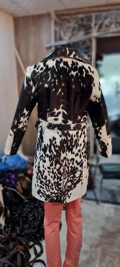 Make a statement with a cow jacket womens look—real cowhide leather, mid-thigh length, bold lapels, and a fitted waist belt.

