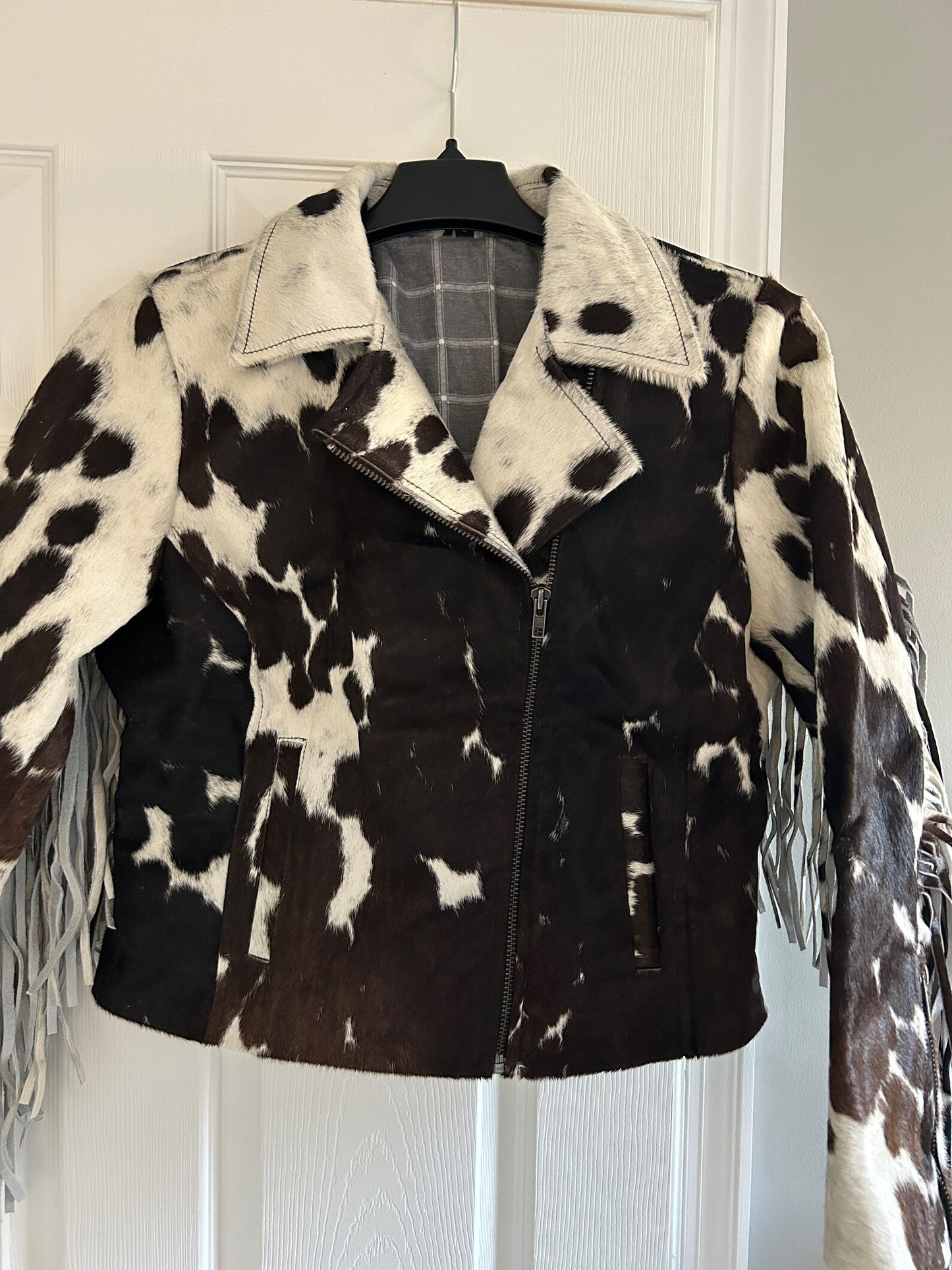 Cow print jacket with real cow hide, structured fit, and full fringe—ideal cowhide jacket women's and men's Western wardrobe essential.

