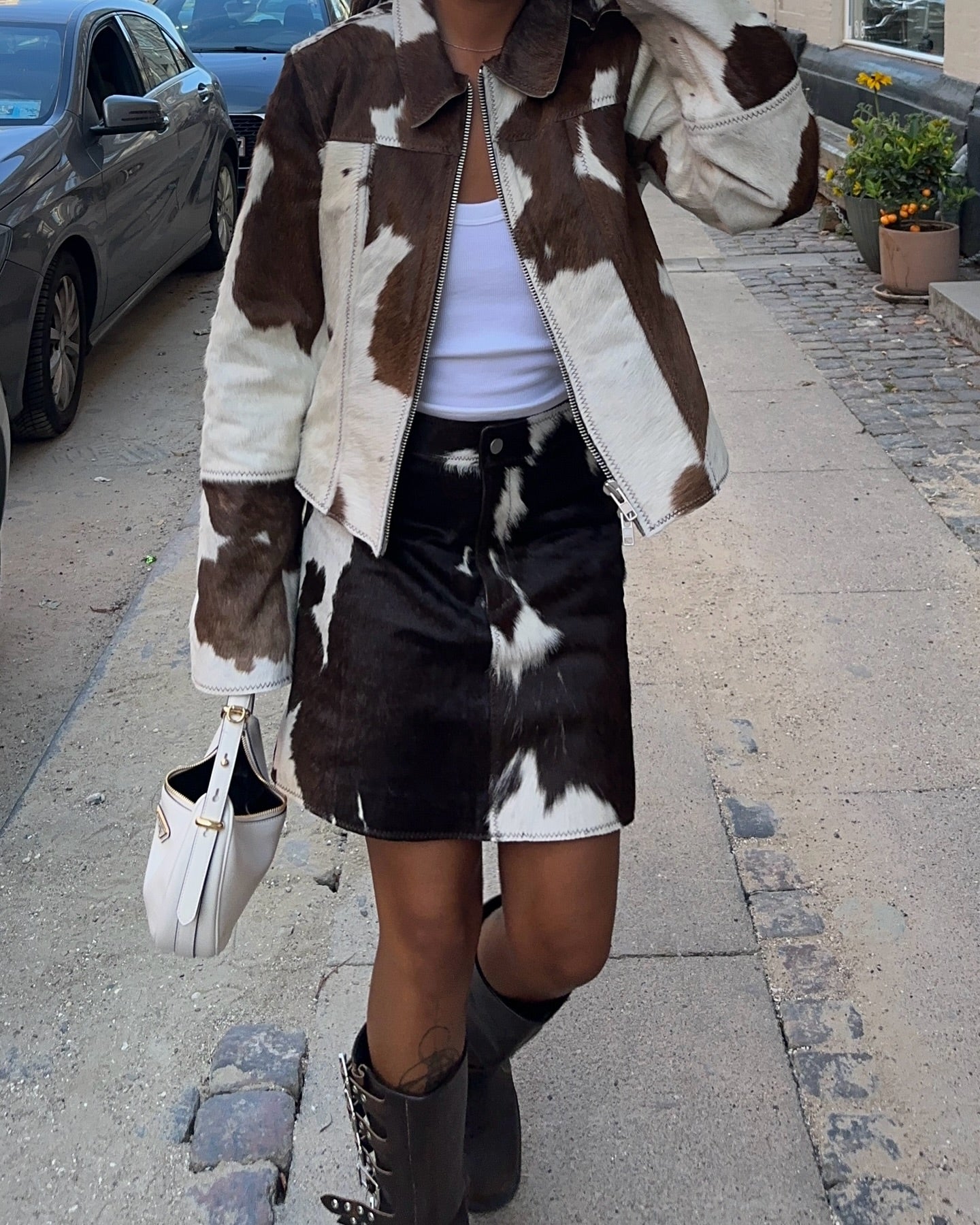 Cowhide leather jacket women love—paired with a real cow hide skirt for a complete Western cowgirl look. Each cow coat and skirt set features bold natural cow print.


