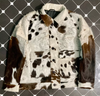 Women's cow jacket made from genuine cowhide with button front, flap pockets, and full hair-on detail. Bold cow coats design perfect for ranch or streetwear.

