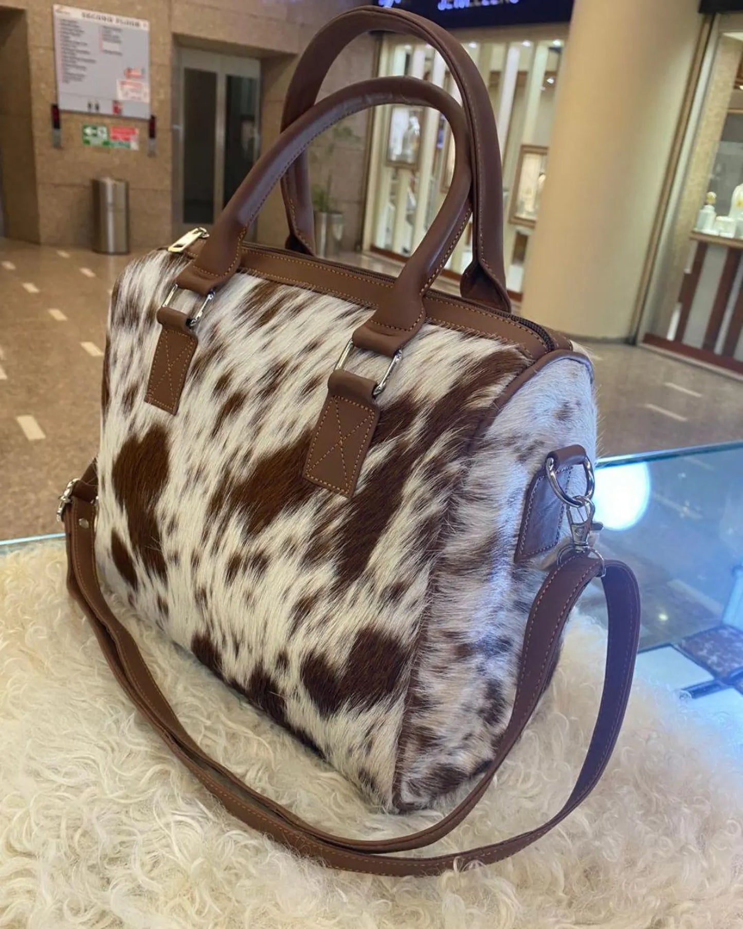 Carry rustic charm with this cowhide purse for women. Genuine pony skin pattern and leather detail give it a bold western style look.