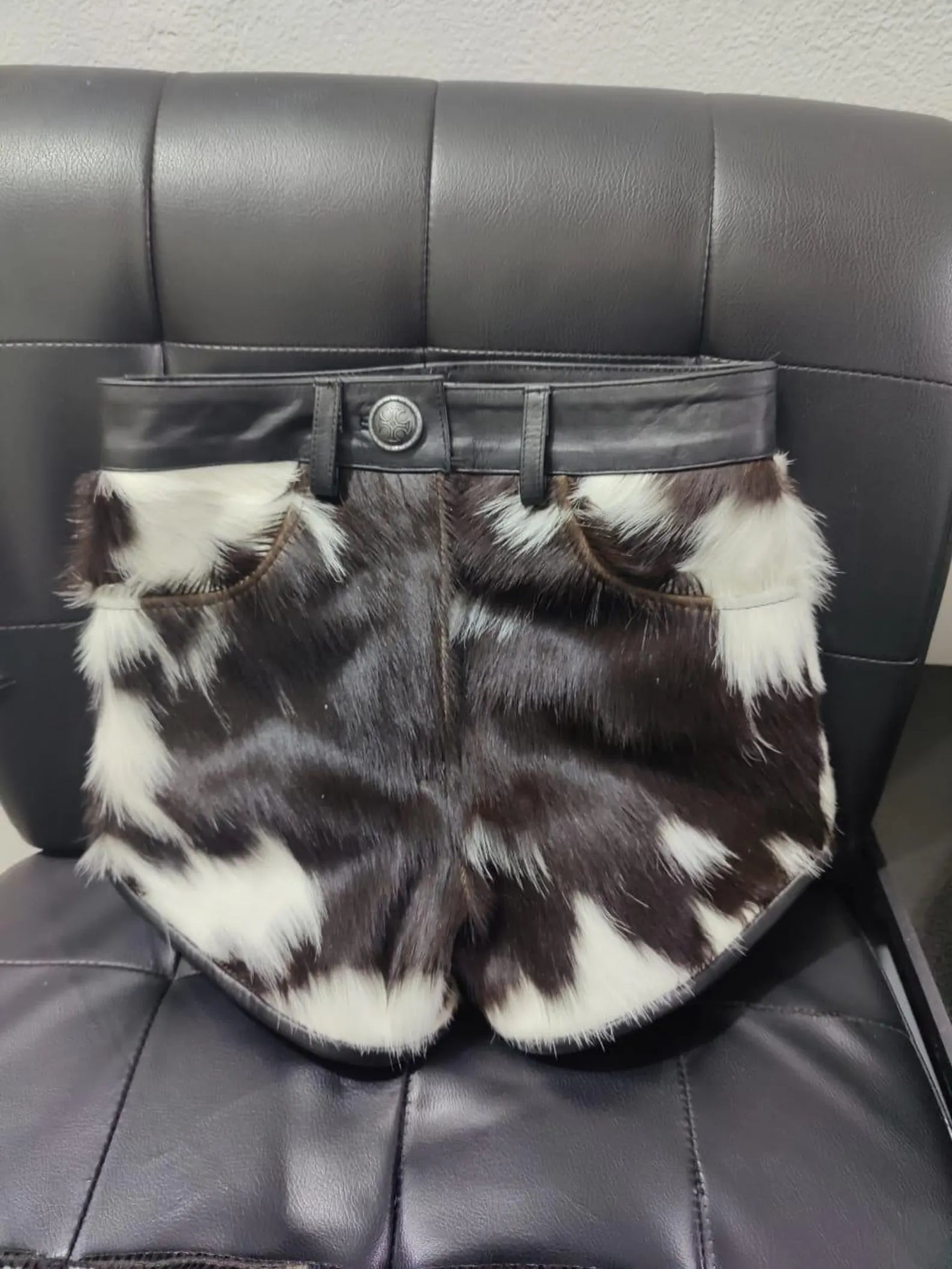 Stand out with real cowhide mini shorts in bold black and white cow print. These women cow skin shorts bring raw Western energy to any streetwear look.

