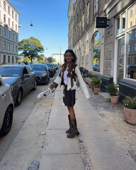 Stand out in a real cow coat and cow hide skirt set—Western cow print design for bold streetwear and rodeo-ready fashion.