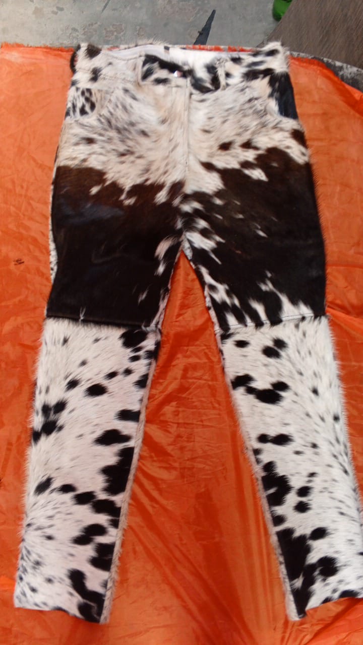Hair-on cowhide trousers with flared bottoms and bold panel layout. Handmade from tricolor cow skin with unique pattern on every pair.

