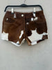Authentic women’s cow print shorts in real hair-on cowhide. Western rodeo and country festival ready with natural brown and white patterns.