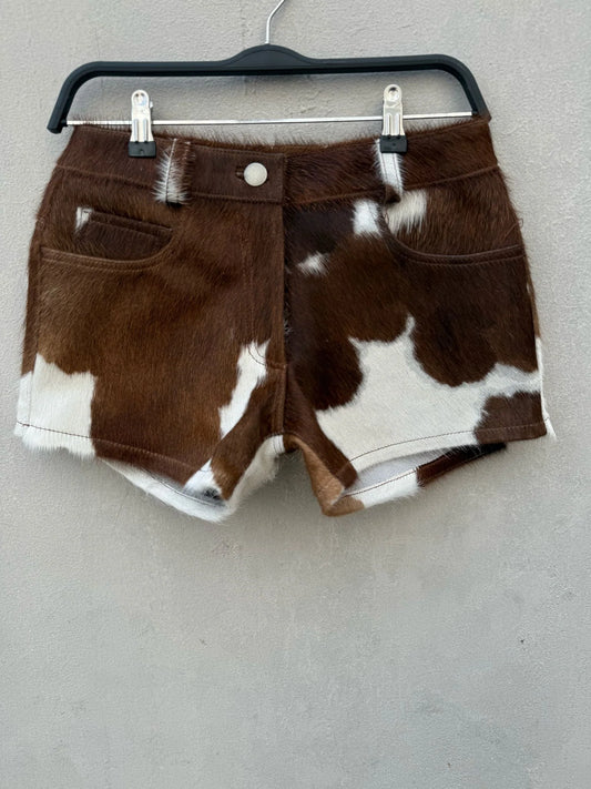 Authentic women’s cow print shorts in real hair-on cowhide. Western rodeo and country festival ready with natural brown and white patterns.