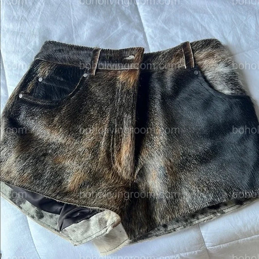 Dark cowhide shorts made from real tricolor cowhide with natural fur texture. High-waisted fit, back pockets, and bold western-inspired design.