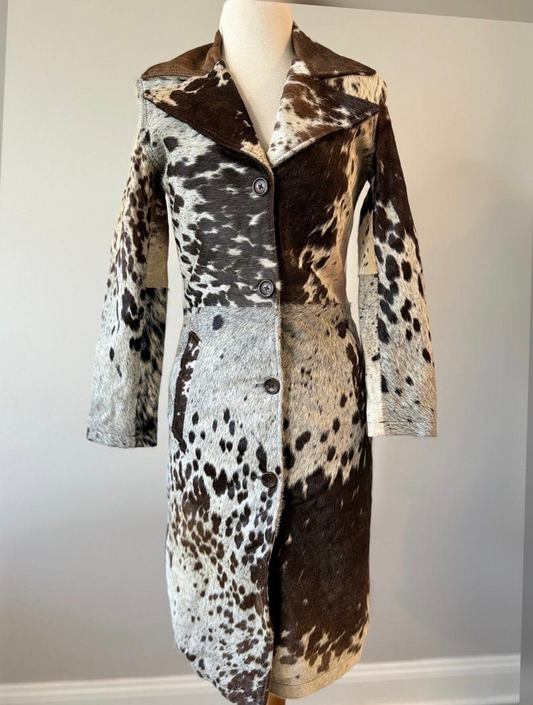 Women’s cowhide fur trench coat in black, brown, and white. Genuine cow skin coat for rodeo, ranch, and western styling events.