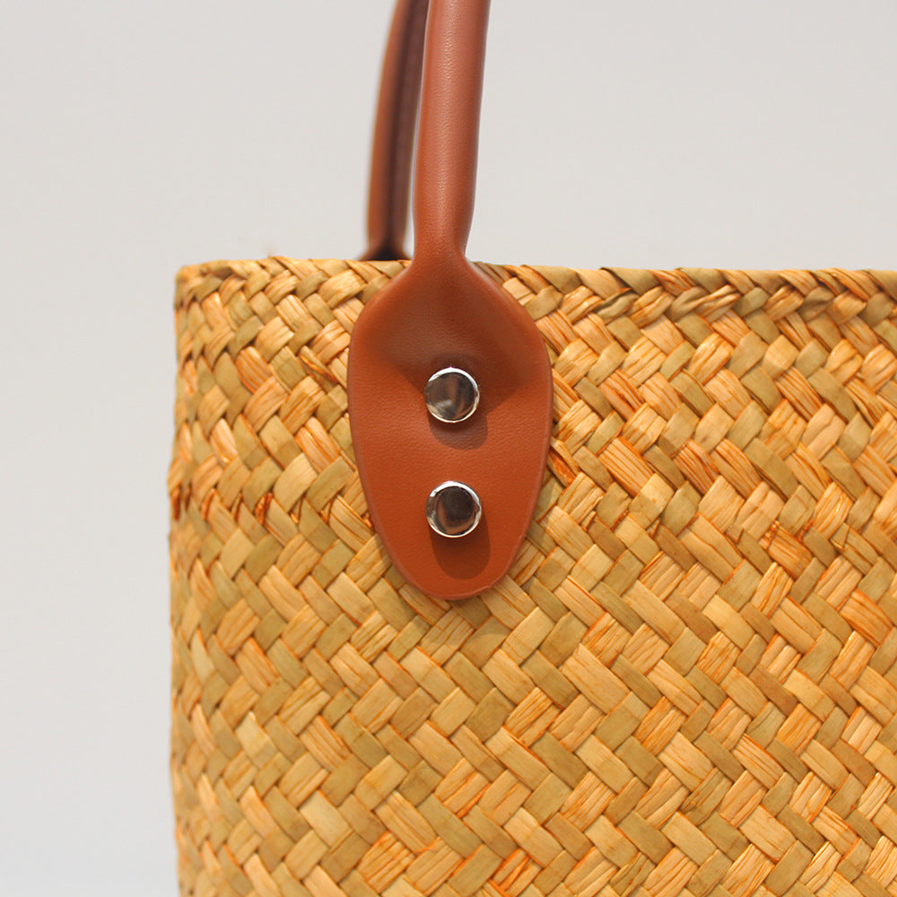 Natural straw beach tote with brown leather handles