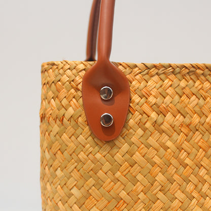 Natural straw beach tote with brown leather handles