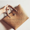Seagrass rattan tote bag with loop closure and structured base. A must-have rattan purse for beach lovers and natural fiber fans.
