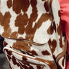 Cozy cow fur backpack perfect for outdoor adventures, offering warmth and style while exploring nature's wonders.